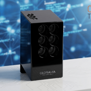 Six-lens black gadget on a white desk with a blue circuitry backdrop and Olorama Technology branding in the background.